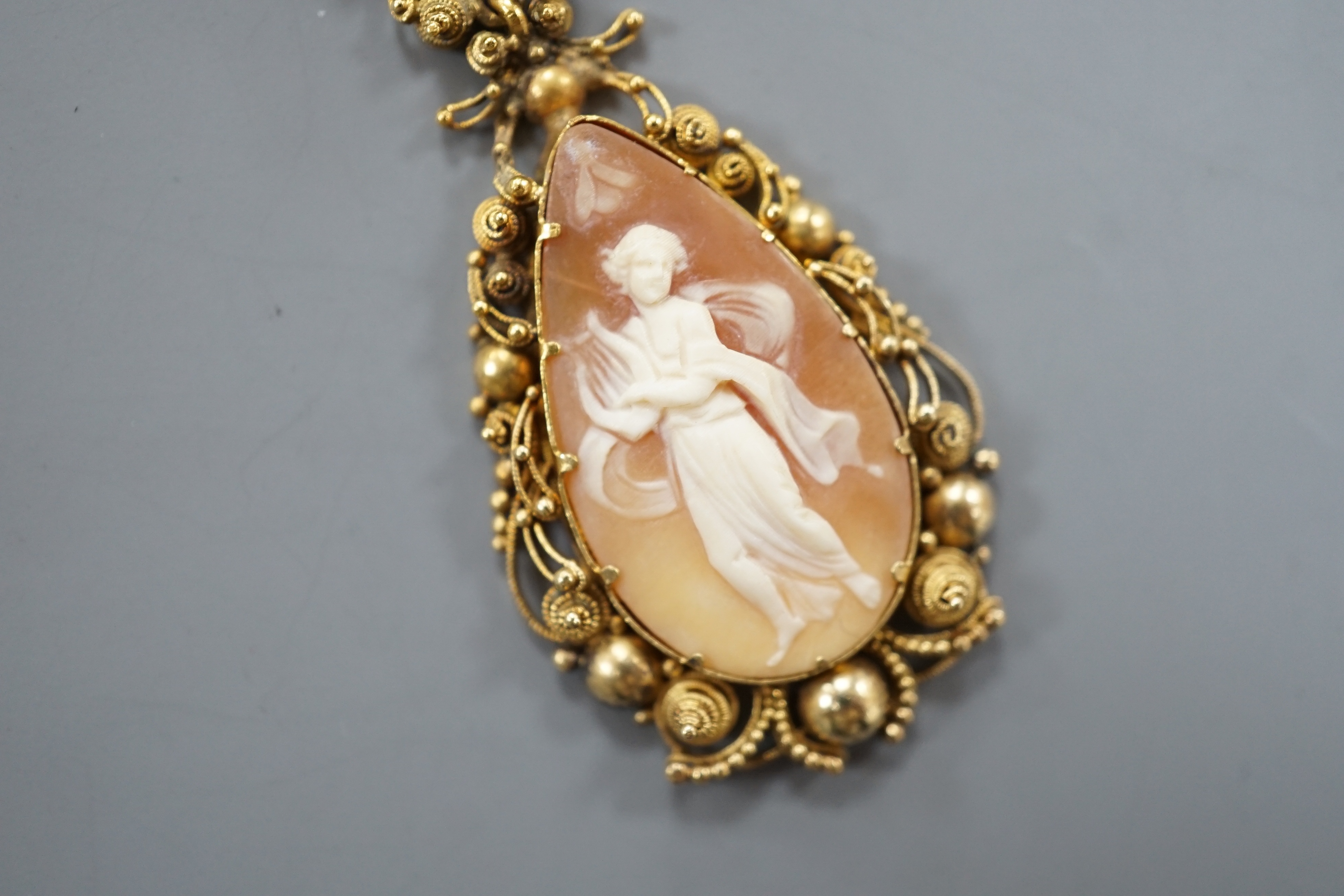 A 9ct and cameo shell set drop pendant necklace, 70cm, gross weight 10.9 grams.